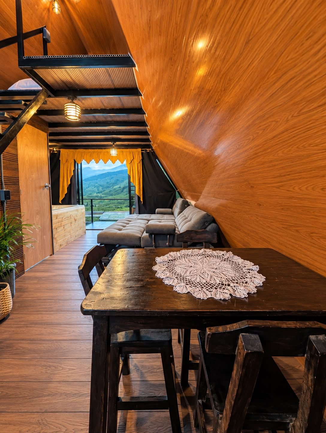 El comedor, con la escalera al segundo nivel y la vista al valle